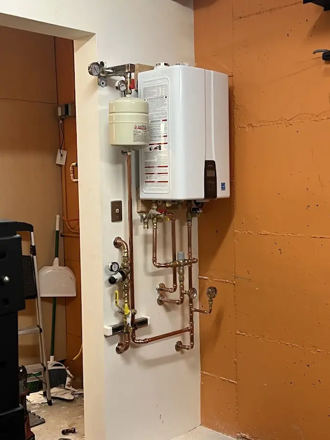 Plumbing technician inspecting water heater connections in Houma